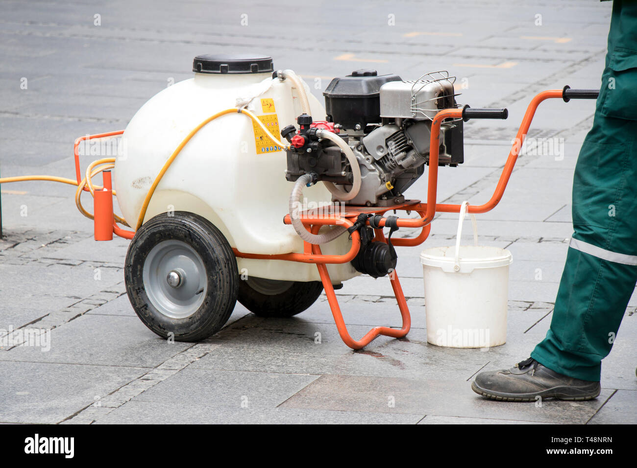 Watercart on wheels, portable watering system on pedestrian street, close up Stock Photo