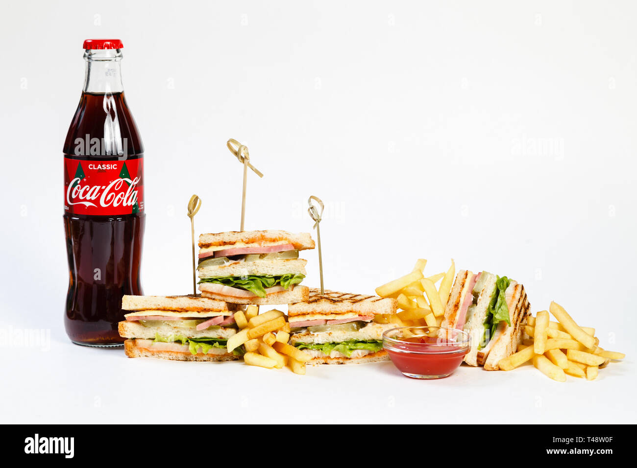 Photo session new menu of coffee house, fresh club sandwich, glass bottle  of Coca Cola, french fries and ketchup isolated on white background.  Concept Stock Photo - Alamy