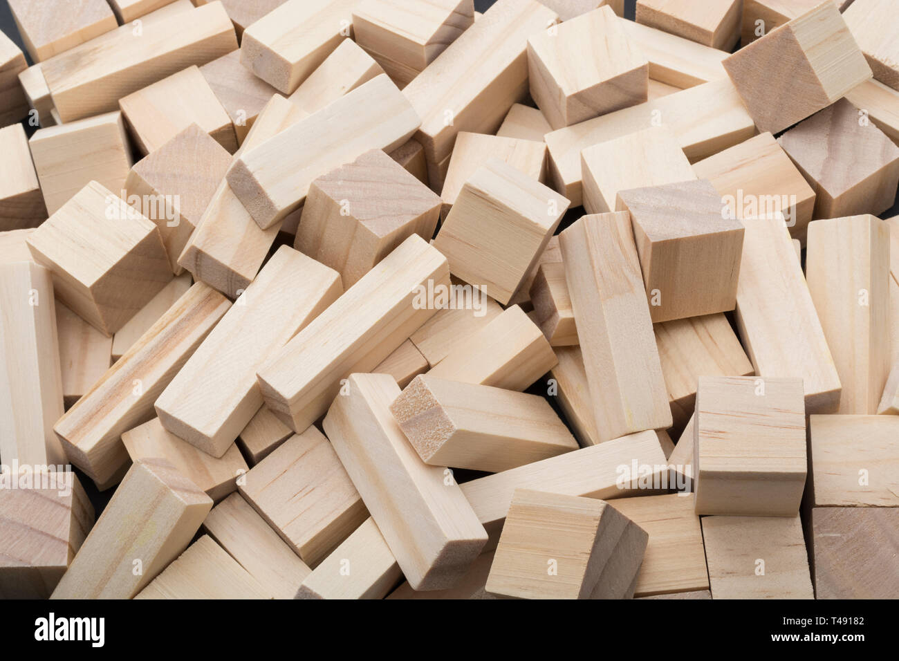 Small wooden bricks scattered in a disorganised pile. Metaphor chaos, US bank collapse, untidy, jumbled up, mixed up, in a muddle, confused thoughts. Stock Photo