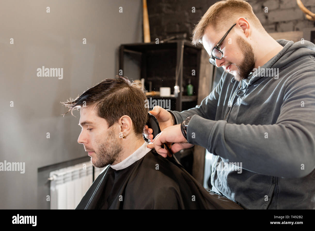 Barber Work With Clipper Machine In Barbershop Professional
