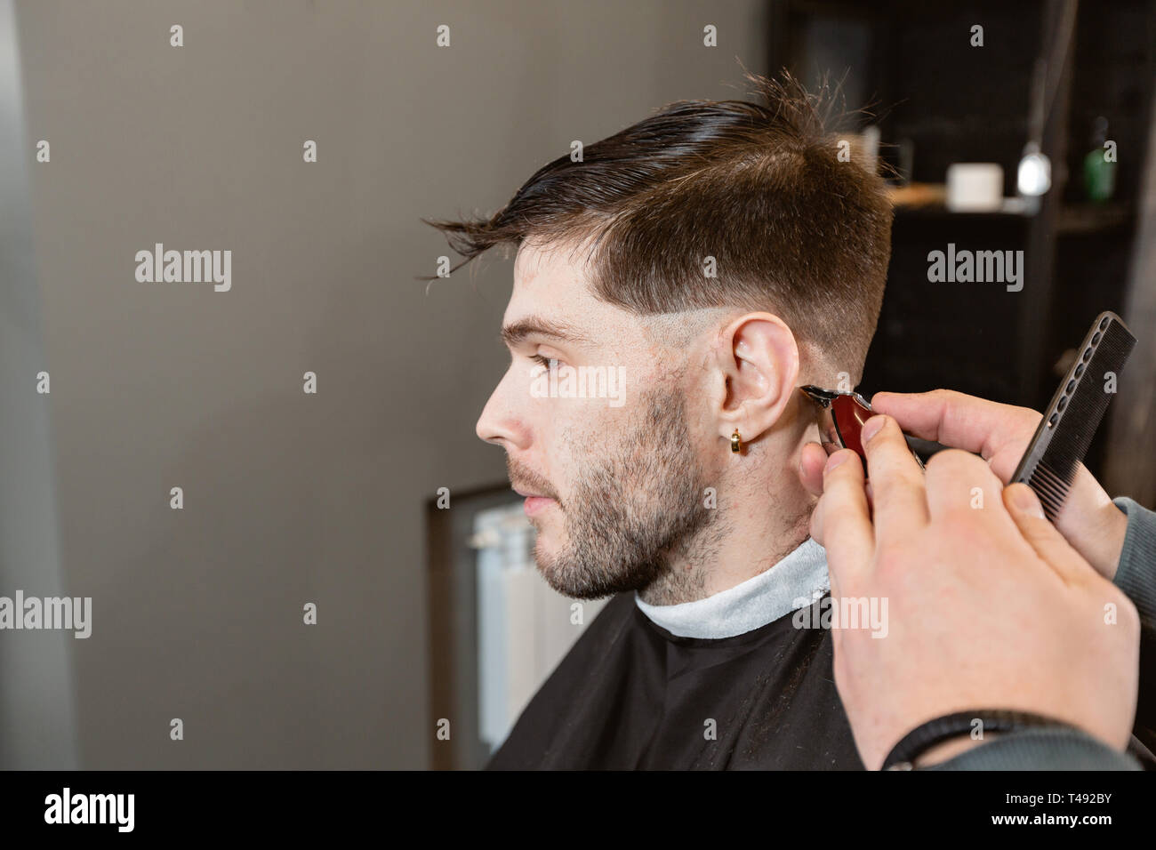 Barber Work With Clipper Machine In Barbershop Professional