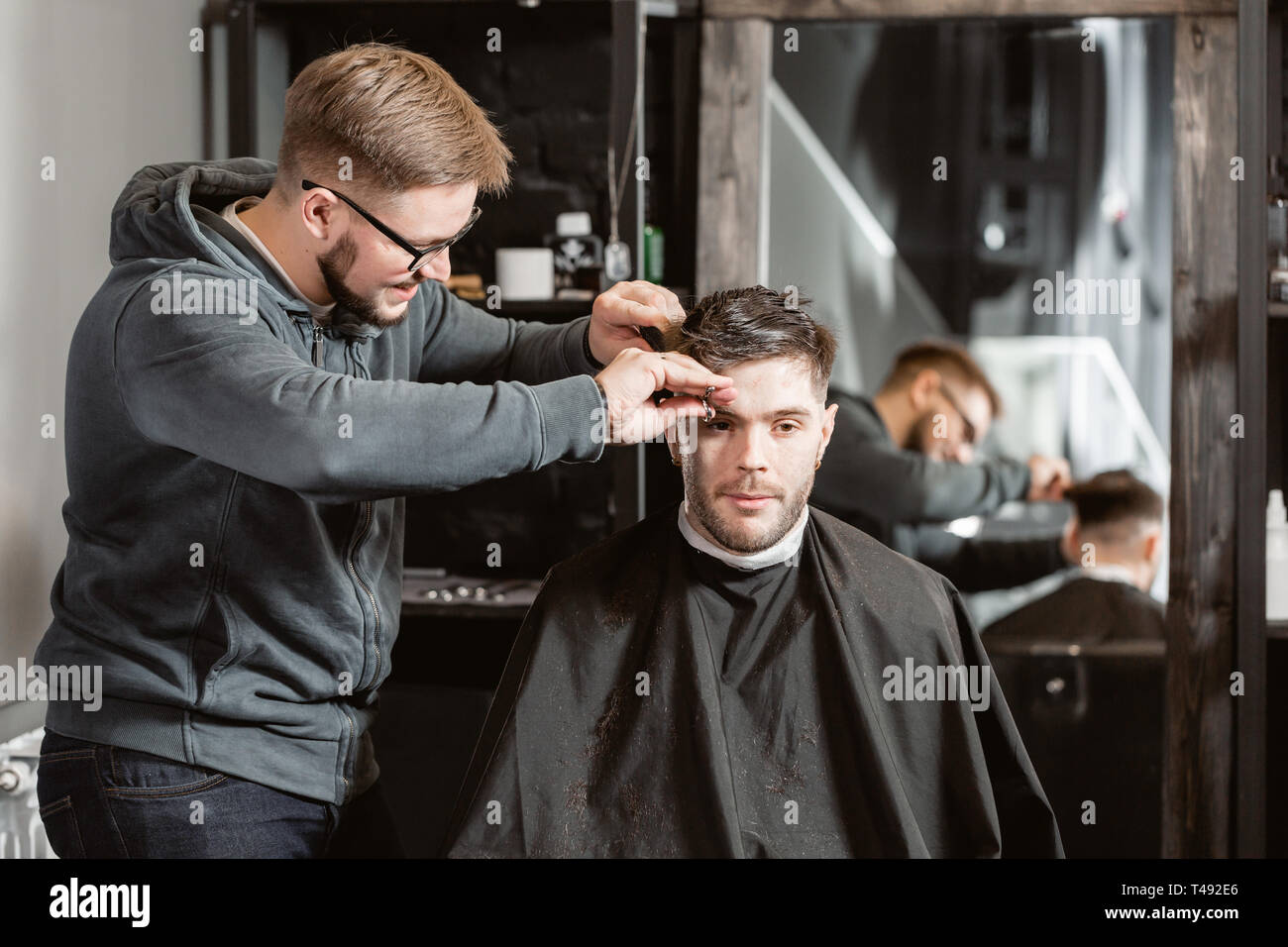 Hair Cutting With Metal Scissors Master Cuts Hair And Beard Of