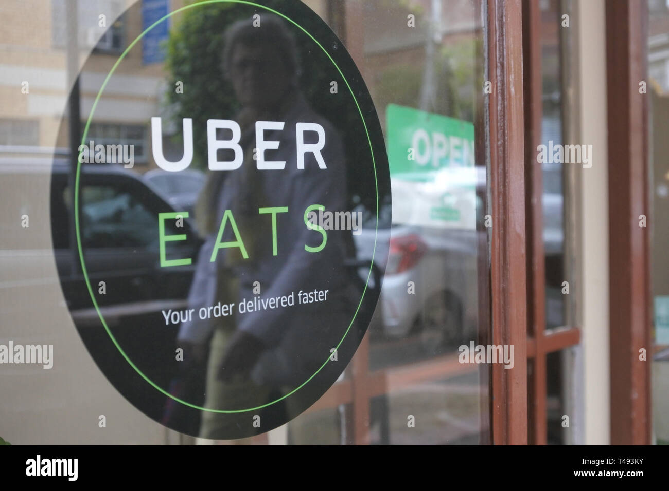 Uber Eats Sign on a restaurant door. Users can order food from 