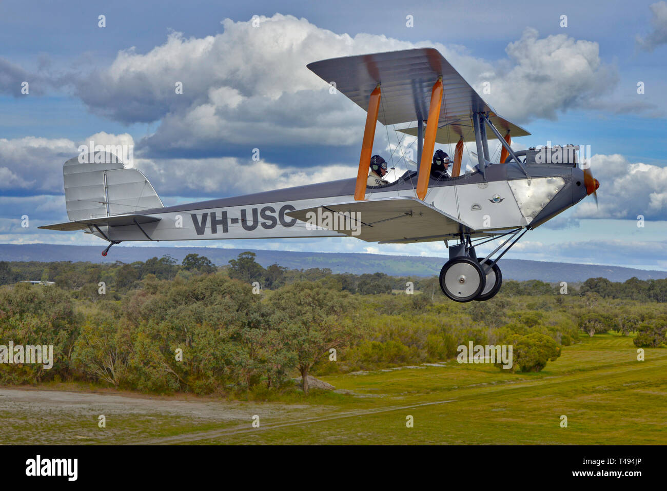 Air to air shot of the one and only Silver Centenary biplane, Western Australia. Flown by the original builders grandson, taking off from Serpentine. Stock Photo