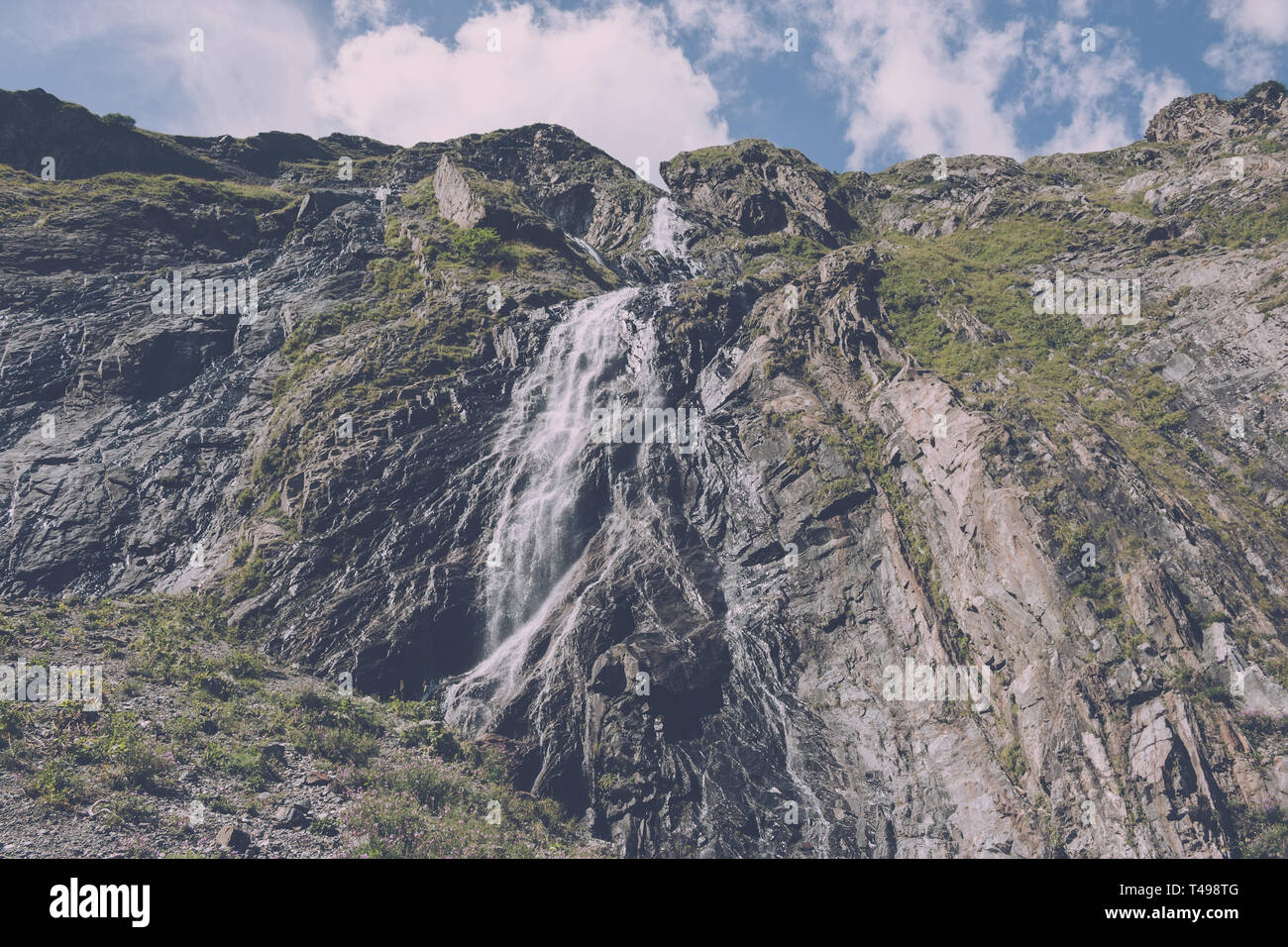 Closeup view waterfall scenes in mountains, national park Dombai, Caucasus, Russia, Europe. Summer landscape, sunshine weather, dramatic blue sky and  Stock Photo