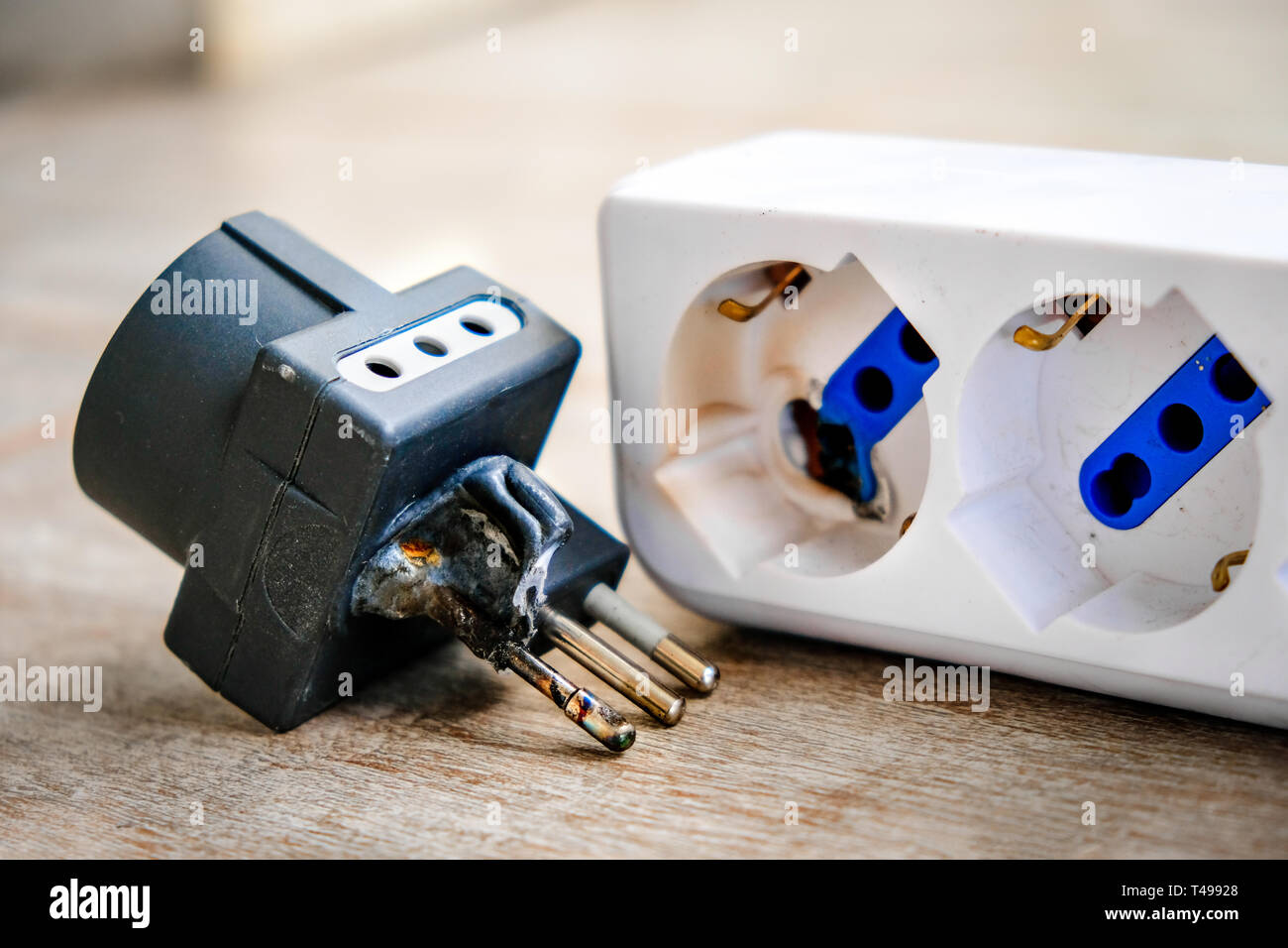 A burnt power strip melted plastic for electrocution danger Stock Photo