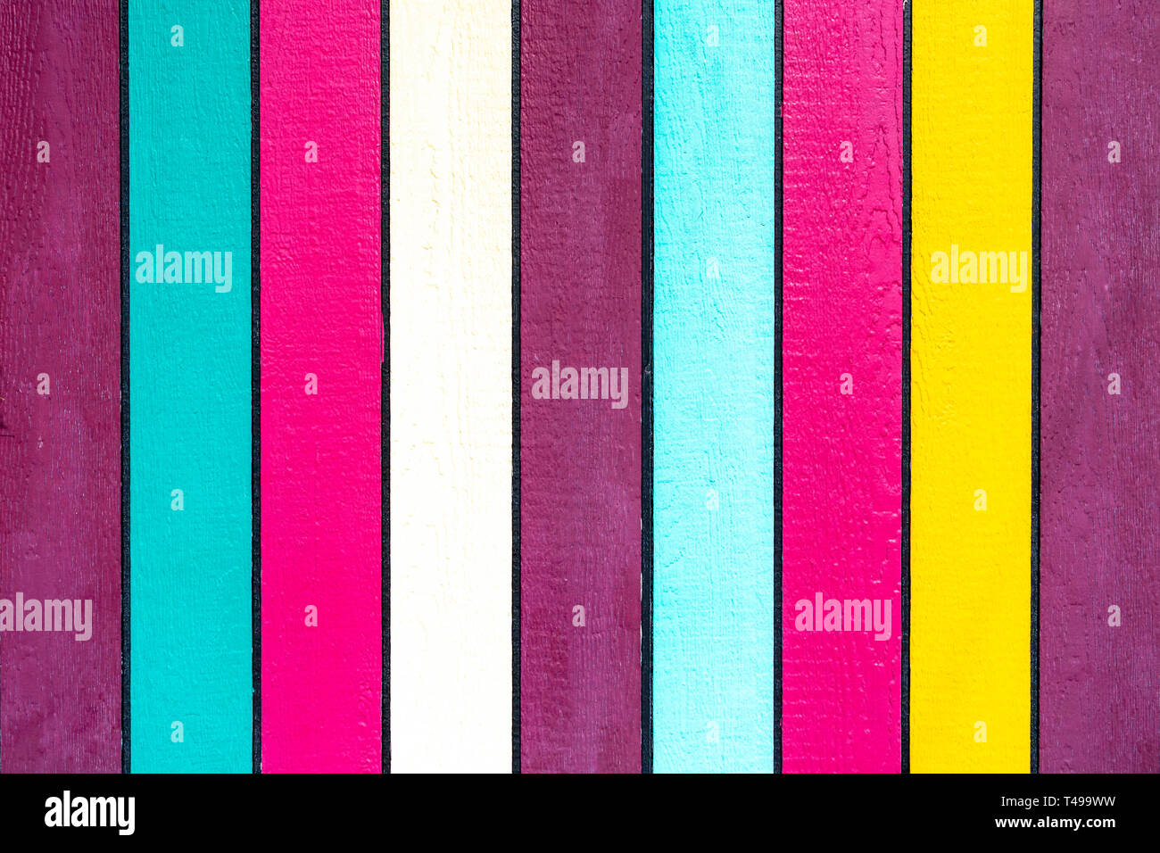 Brightly painted colourful vertical strips of wood Stock Photo