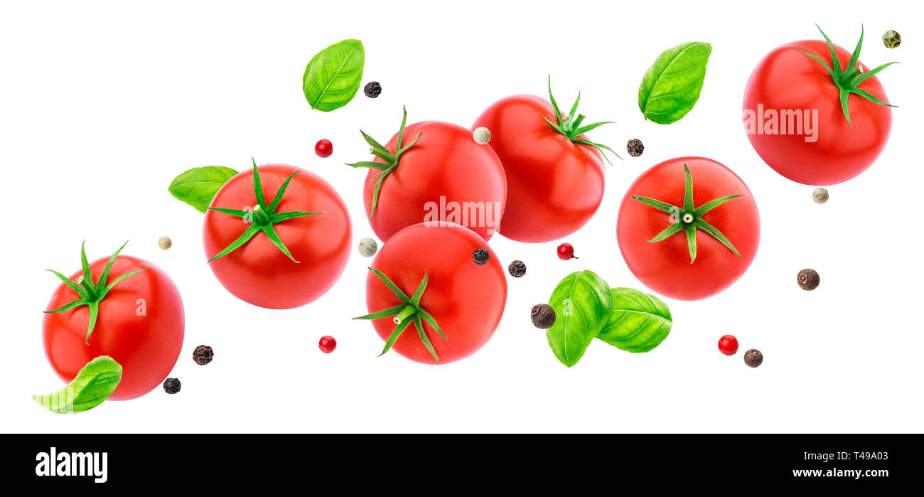 Falling tomatoes salad isolated on white background with clipping path, flying fresh vegetables ingredient Stock Photo