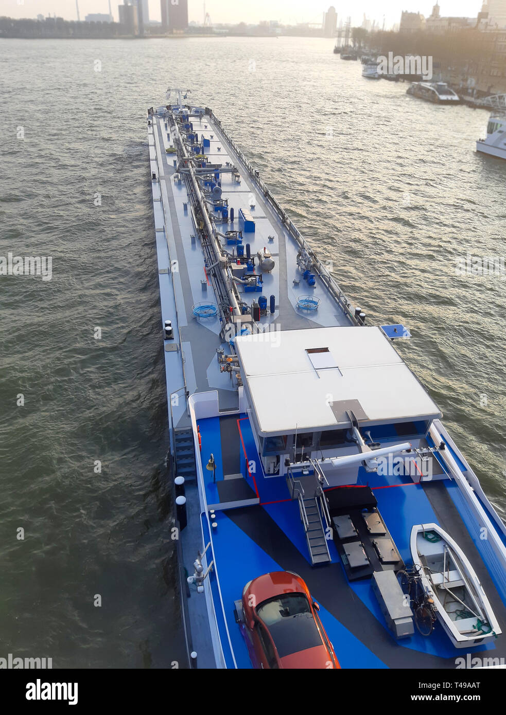 Top view of big blue barge in the port on blue sea background. Cargo transportation and transport services by sea. Stock Photo