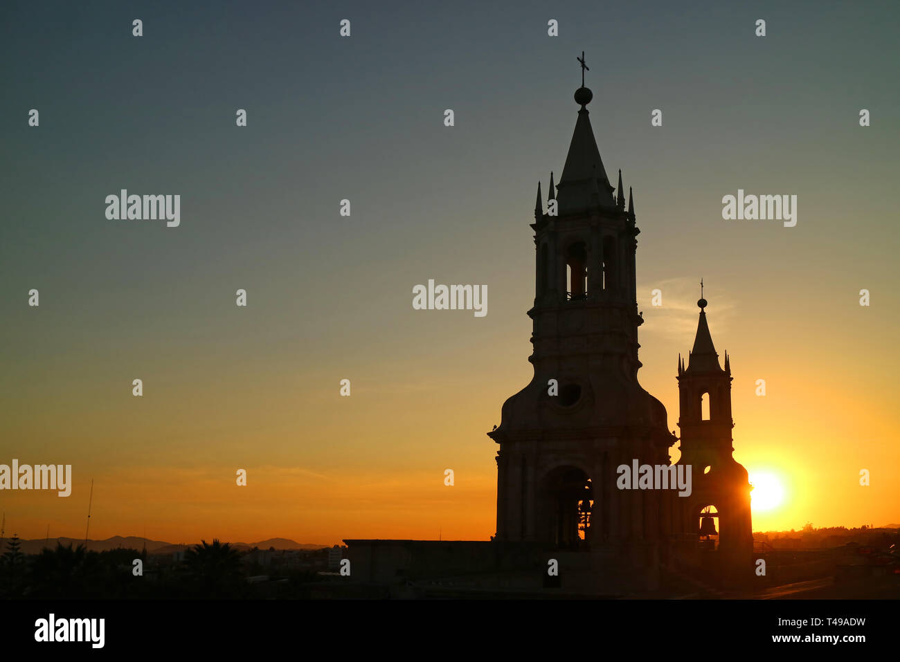 Silhouette of the Iconic Bell Tower of Basilica Cathedral of Arequipa against the Setting Sun, Peru Stock Photo