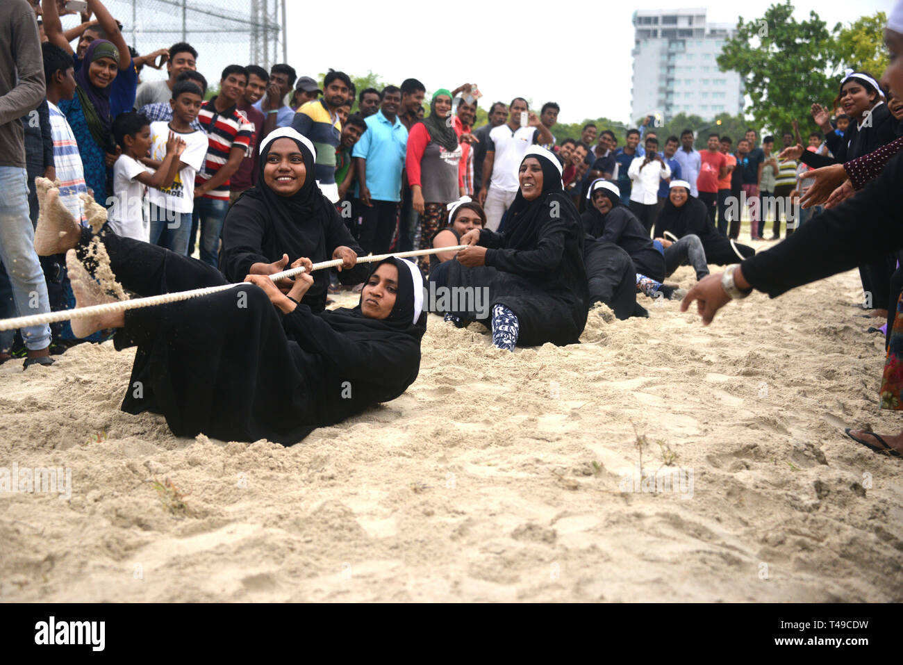 Maldivian women pulling rope for fun Stock Photo