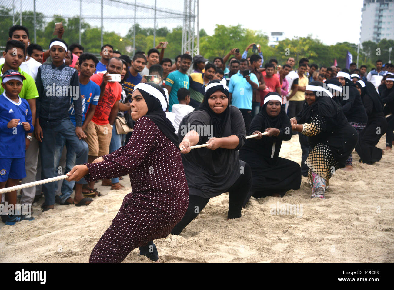 Maldivian women pulling rope for fun Stock Photo
