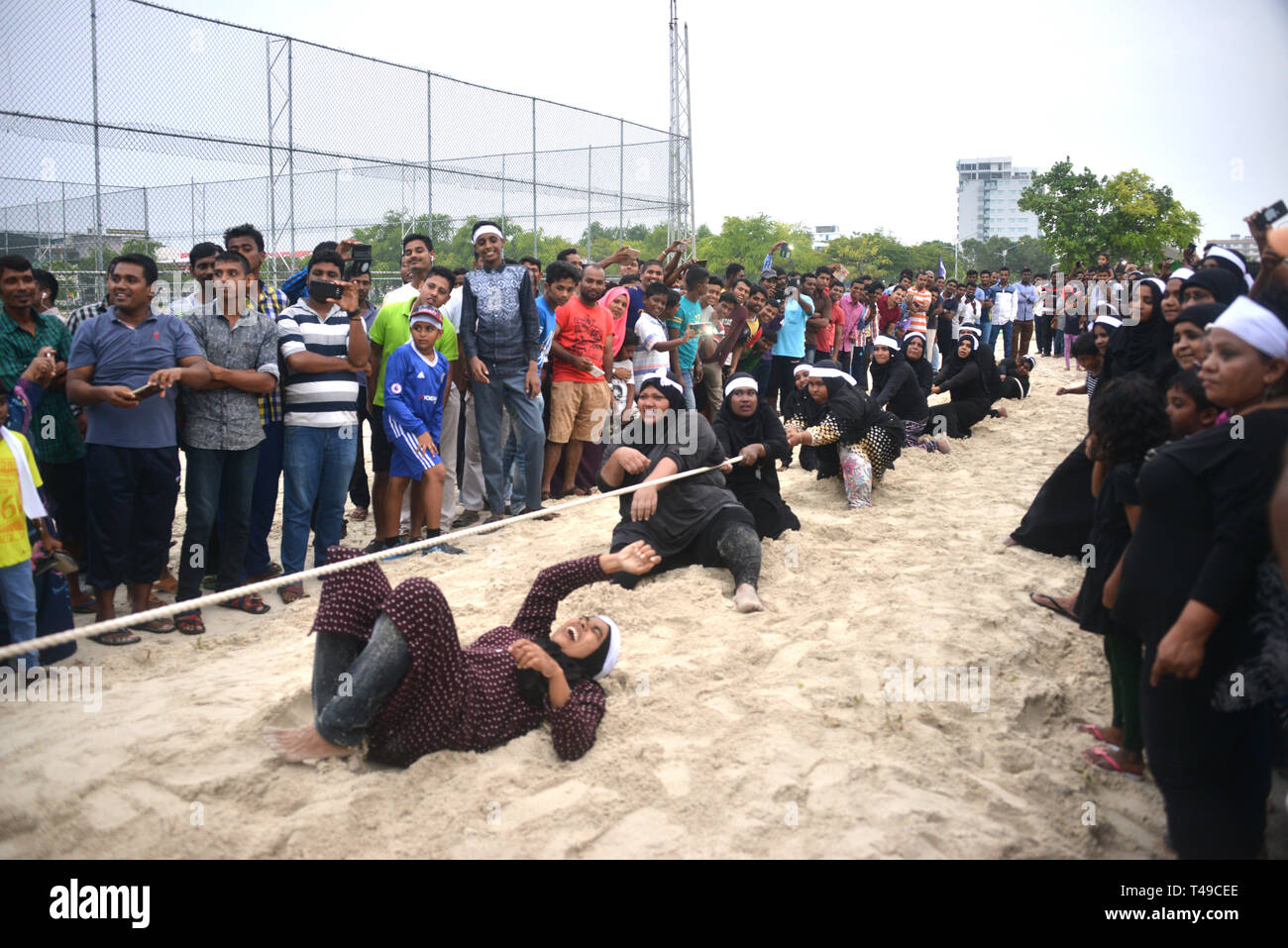 Maldivian women pulling rope for fun Stock Photo