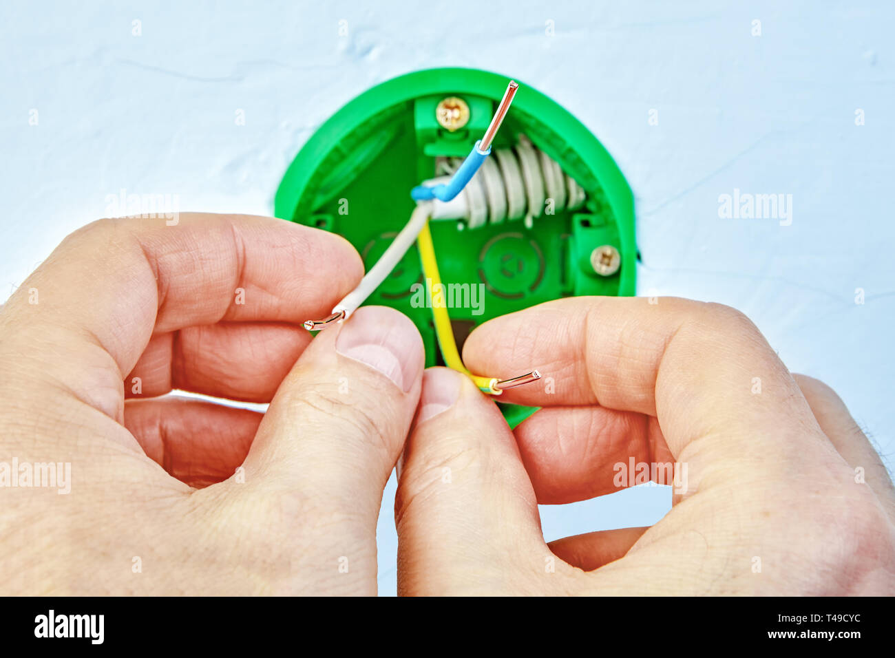 Installing of household electrical power outlet or switch, electric