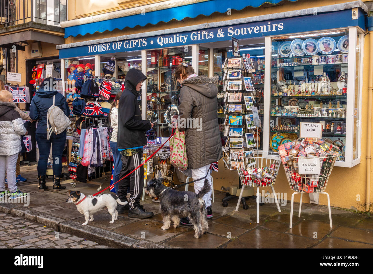 Tourists browse gifts at a souvenir shop in Church Street, Windsor, UK Stock Photo