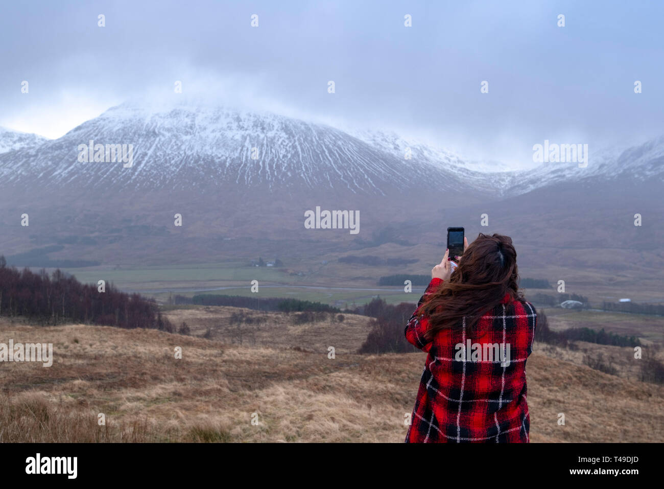 Person taking pictures of the landscape in the Scottish Highlands, Scotland, UK, Europe Stock Photo