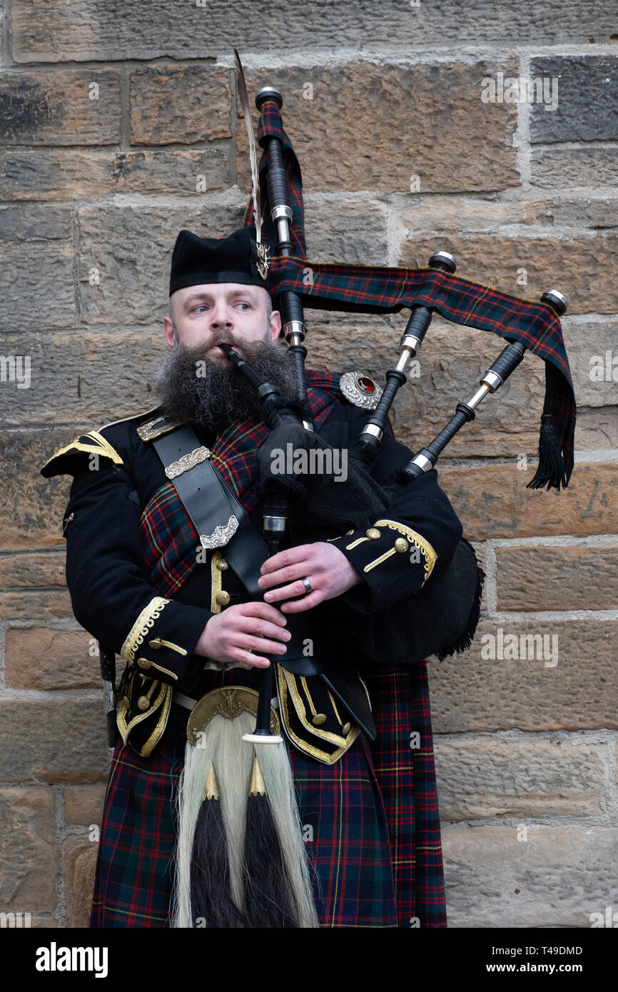 Scottish man playing the bagpipes Stock Photo