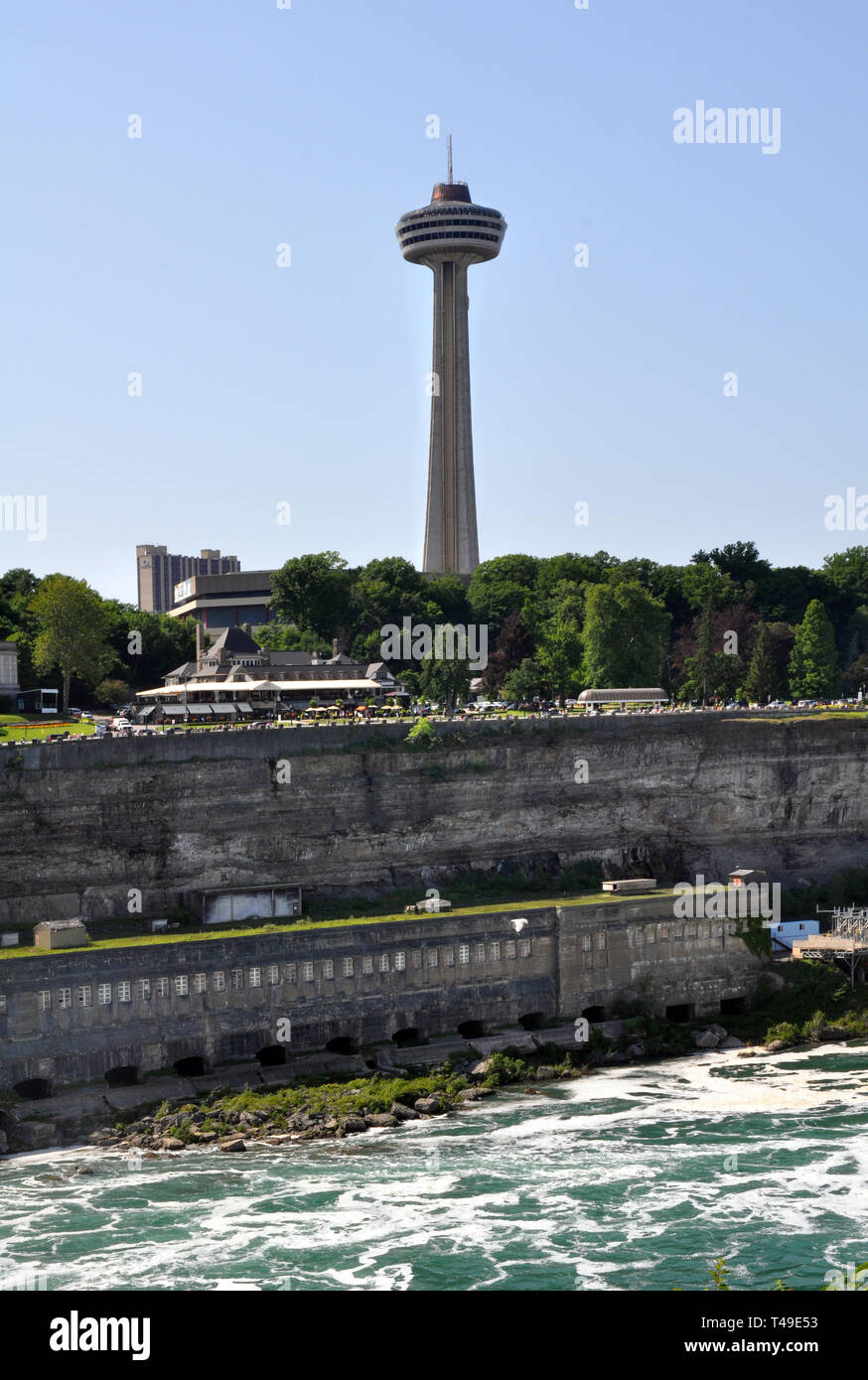A View of Skylon Tower and the old Niagara Hydroelectric power plant below along the river at Niagara Falls Canada Stock Photo