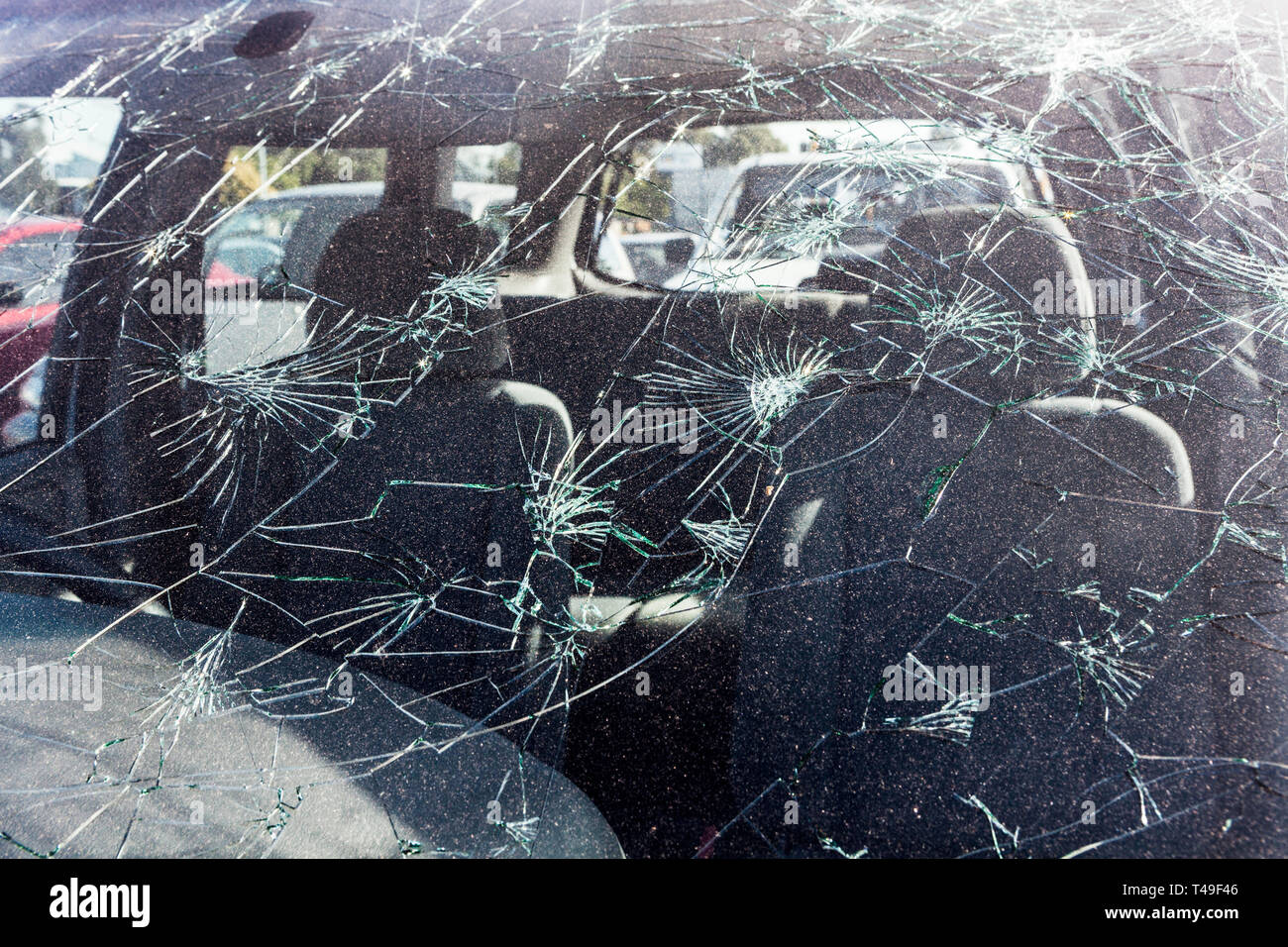 Hailstone damage on the front windscreen of a car Stock Photo