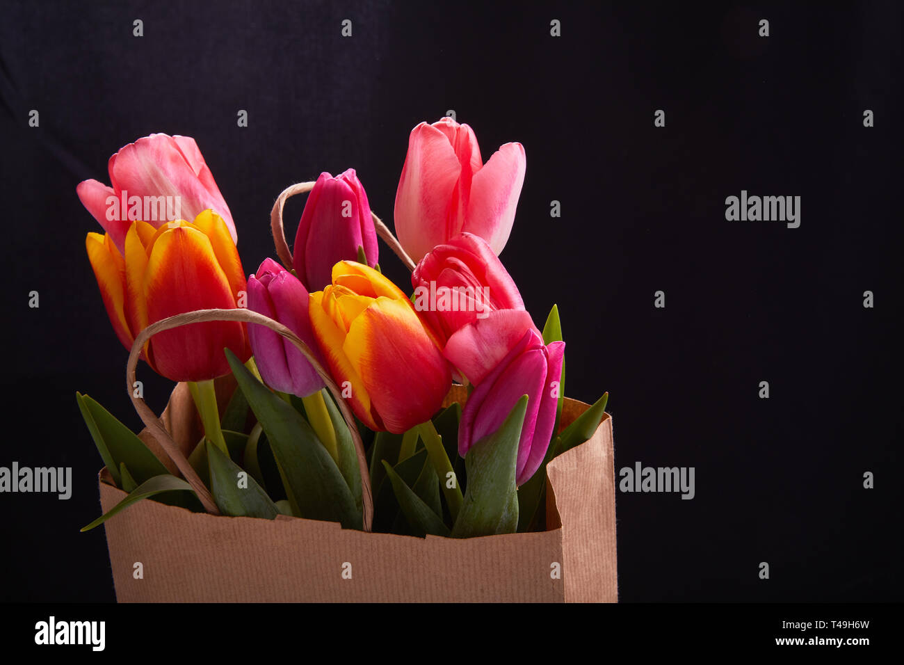 colorful flower bouquet in paper gift bag Stock Photo - Alamy