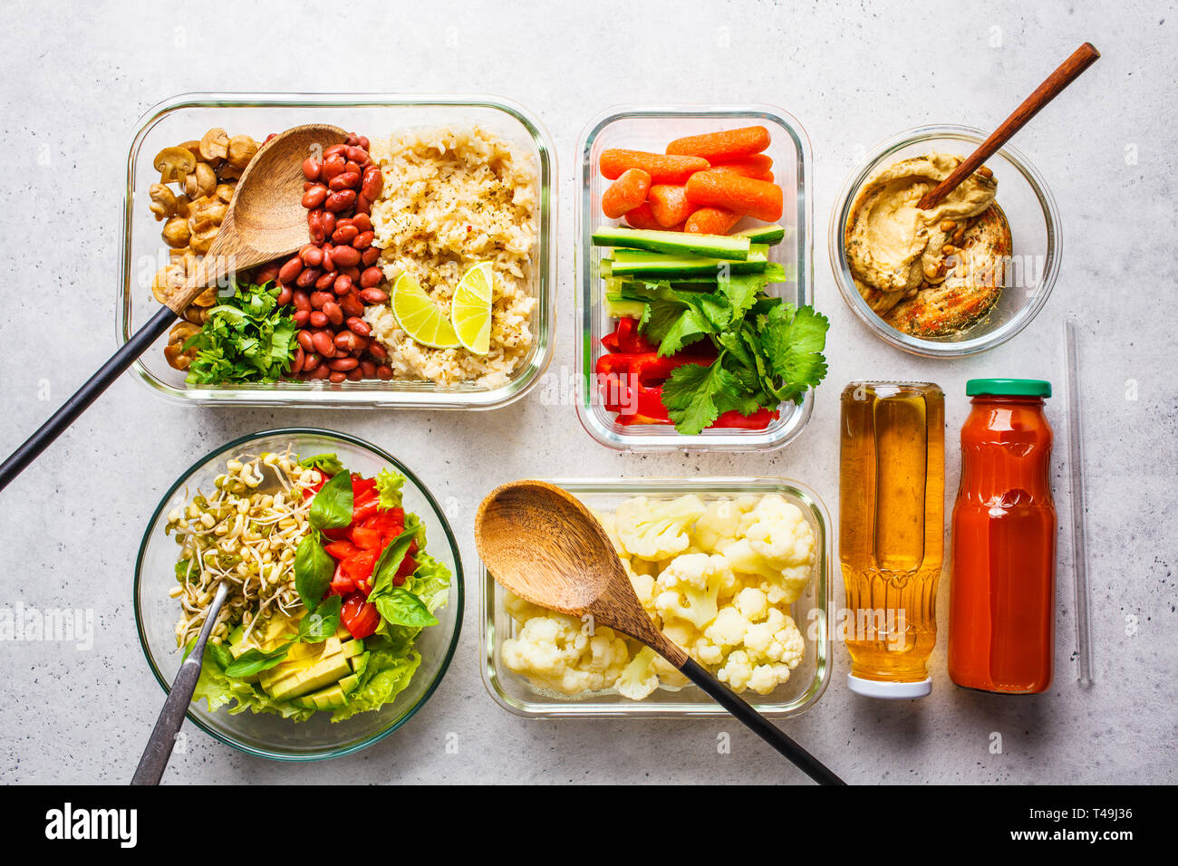 Healthy vegan food in glass containers, top view. Rice, beans