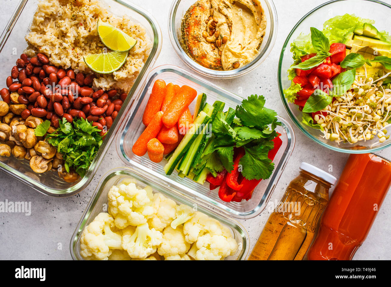 Healthy vegan food in glass containers, top view. Rice, beans