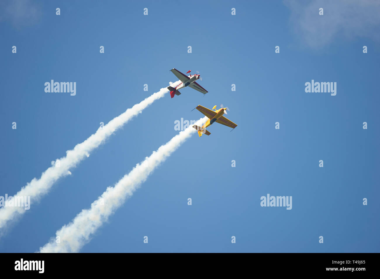 CAP 231 Stunt Aircraft during a display with smoke trails against a blue summer sky Stock Photo