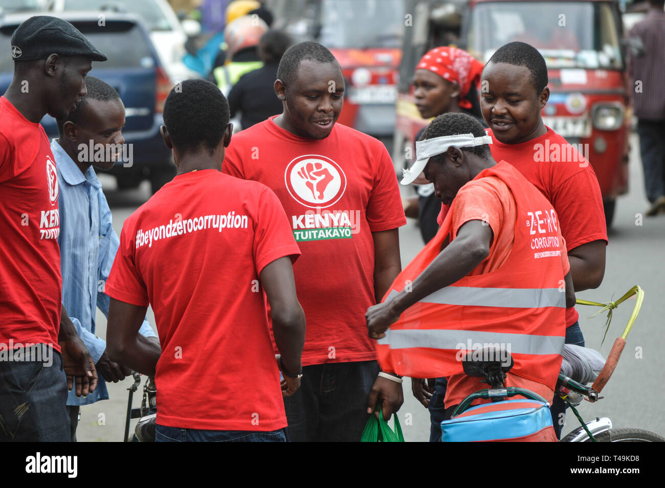 Nakuru, Rift Valley, Kenya. 14th Apr, 2019. A group of activists allied to Kenya's Red Vests Movement are seen engaging a member of the public in the streets of Nakuru during the anti-corruption protest.Activists allied to Kenya's Red Vests Movement were protesting silently about increased levels of corruption in the government, the activists are demanding action to be taken against all government officials involved in corruption. Credit: ZUMA Press, Inc./Alamy Live News Stock Photo