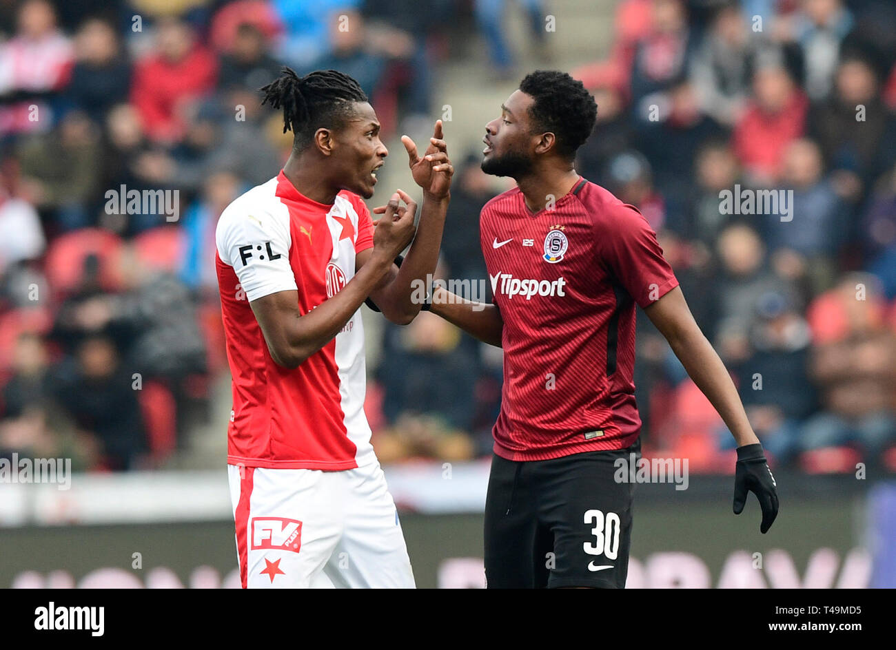 Prague, Czech Republic. 14th Apr, 2019. L-R Simon Deli (Slavia) and  Benjamin Tetteh (Sparta) are seen during the Czech first soccer league  (Fortuna Liga), 28th round, match SK Slavia Praha vs AC