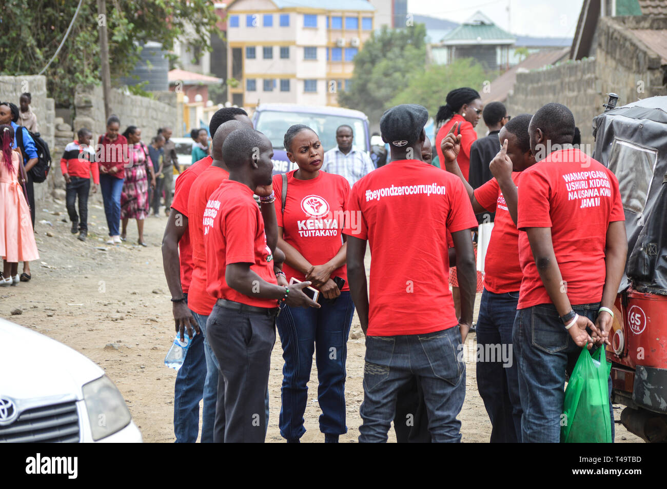 A group of activists allied to  Kenya’s Red Vests Movement are seen discussing after a church service. Activists allied to Kenya’s Red Vests Movement were protesting silently about increased levels of corruption in the government, the activists are demanding action to be taken against all government officials involved in corruption. Kenya loses billions of dollars to corruption in government departments every year and very less action is taken to curb the vice. Every Sunday the activists conduct an anti-corruption protest in churches and streets in different towns of Kenya hoping that the gove Stock Photo