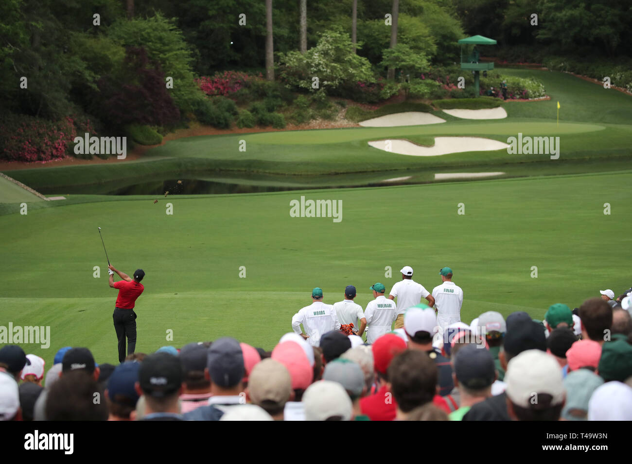 Augusta, USA. 14th Apr 2019. Tiger Woods (USA) plays a shot on the 12th  hole during the final round of the 2019 Masters golf tournament at the Augusta  National Golf Club in