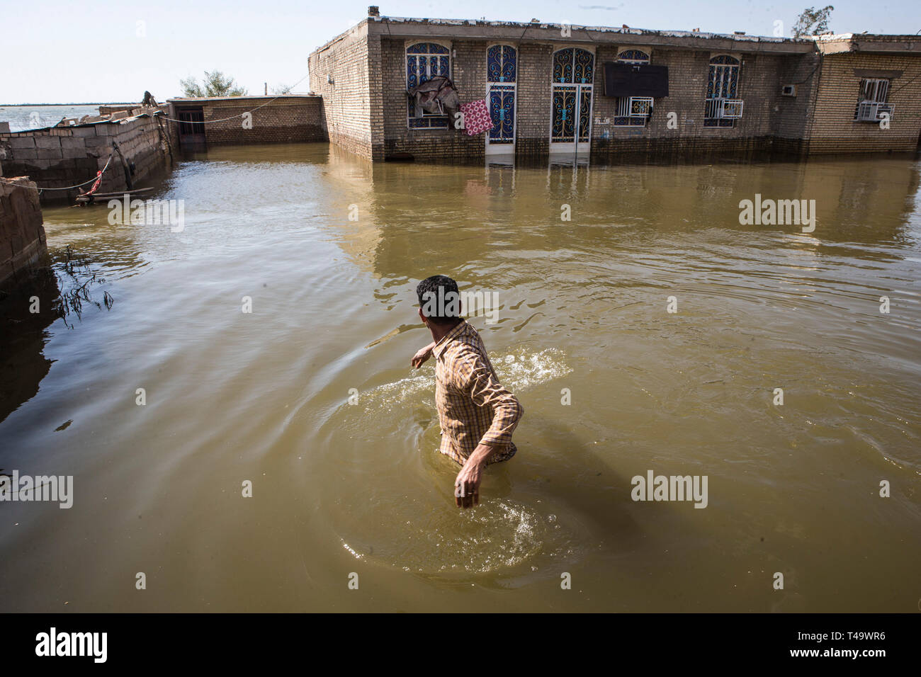 Beijing, Iran. 13th Apr, 2019. A man wades through flood water in Khuzestan Province, Iran, on April 13, 2019. Credit: Ahmad Halabisaz/Xinhua/Alamy Live News Stock Photo