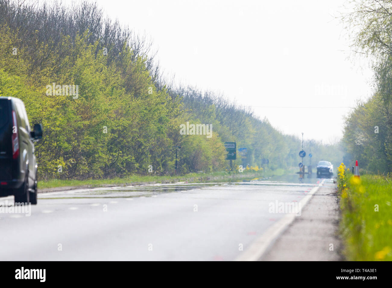 Ashford, Kent, UK. 15th Apr, 2019. UK Weather: Hot and sunny weather on the A259 heading towards Hastings as the hazy hot weather forms a mirage on the asphalt. © Paul Lawrenson 2019, Photo Credit: Paul Lawrenson/ Alamy Live News Stock Photo