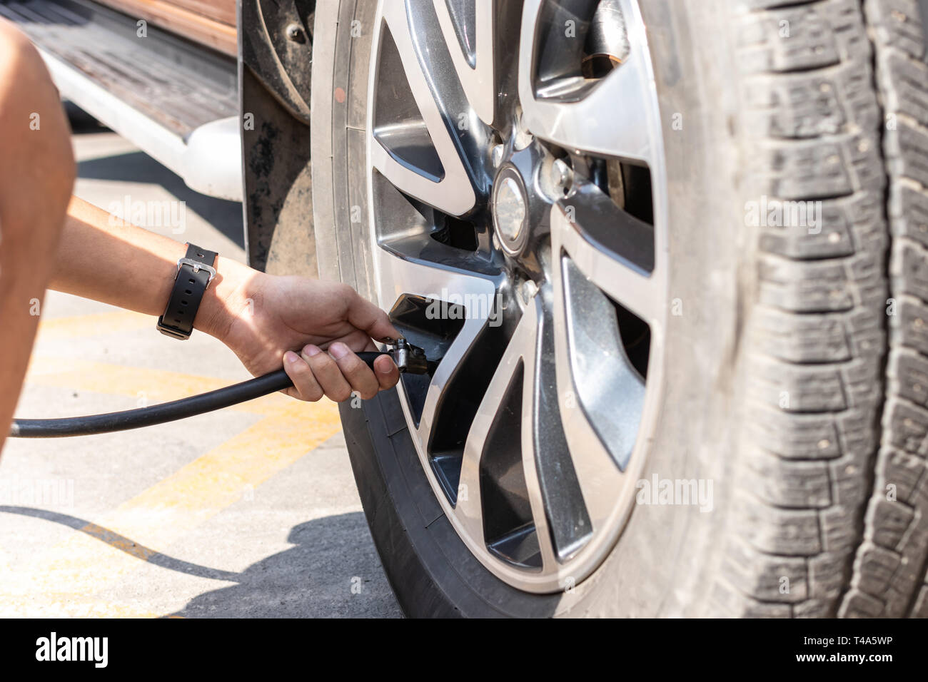 Fitting Cap To Air Valve On Car Tyre Stock Photo - Download Image