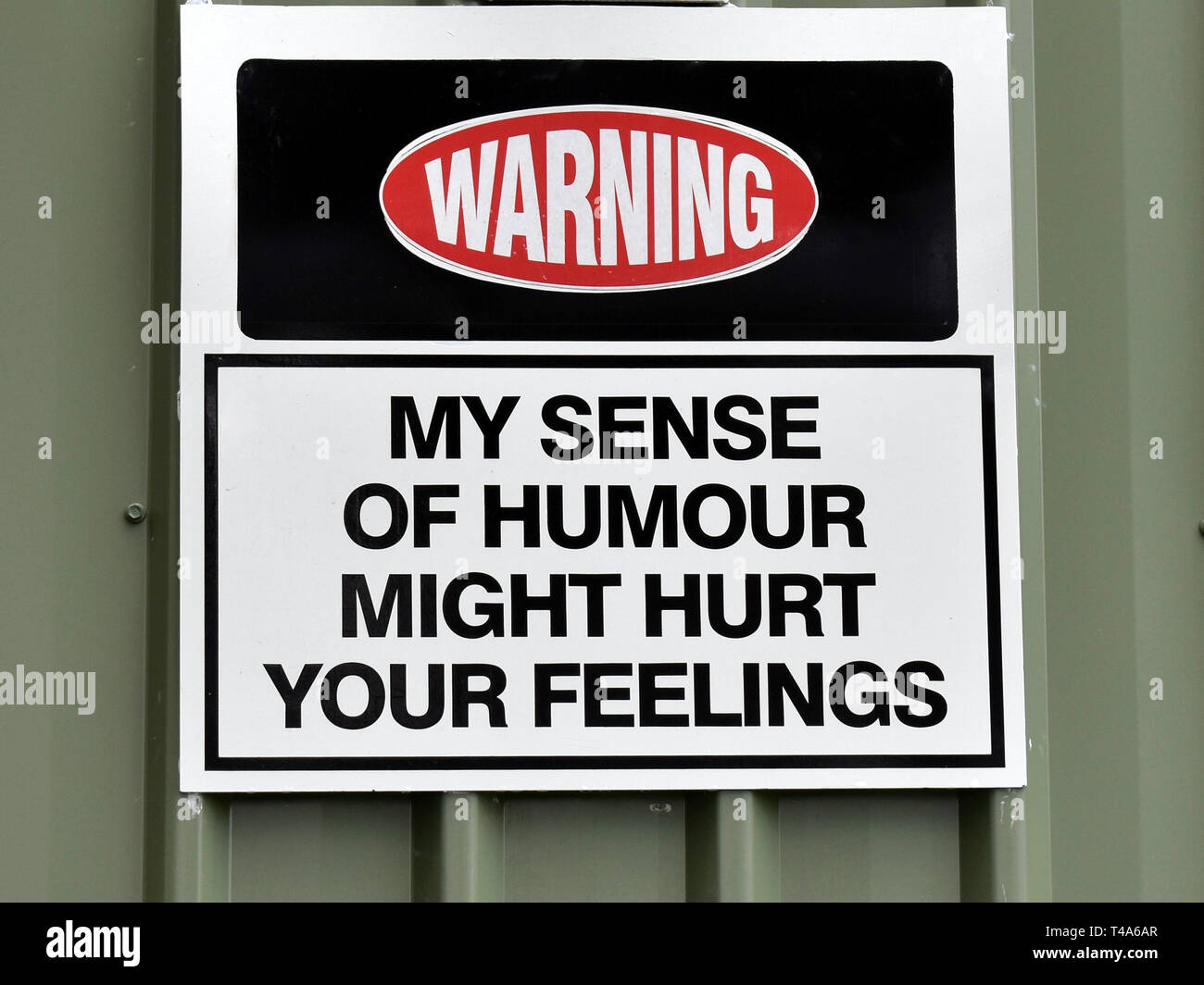 An amusing sign attached to a building warning 'My sense of humour might hurt your feelings' Stock Photo