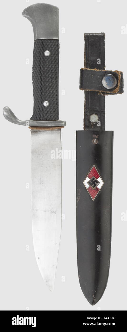 A German Youth knife, without maker's mark Single-edged blade, aluminium hilt with black plastic grip plates. Black lacquered iron scabbard with applied enamelled emblem and black riveted leather hanger. Length 20 cm. Rare 'Fahrtenmesser', historic, historical, 1930s, 1930s, 20th century, Hitler Youth, organisation, organization, organizations, organisations, youth organization, youth organizations, NS, National Socialism, Nazism, Third Reich, German Reich, knife, knives, thrusting, thrustings, weapon, arms, weapons, arms, object, objects, stills, clipping, clippings, cut o, Editorial-Use-Only Stock Photo