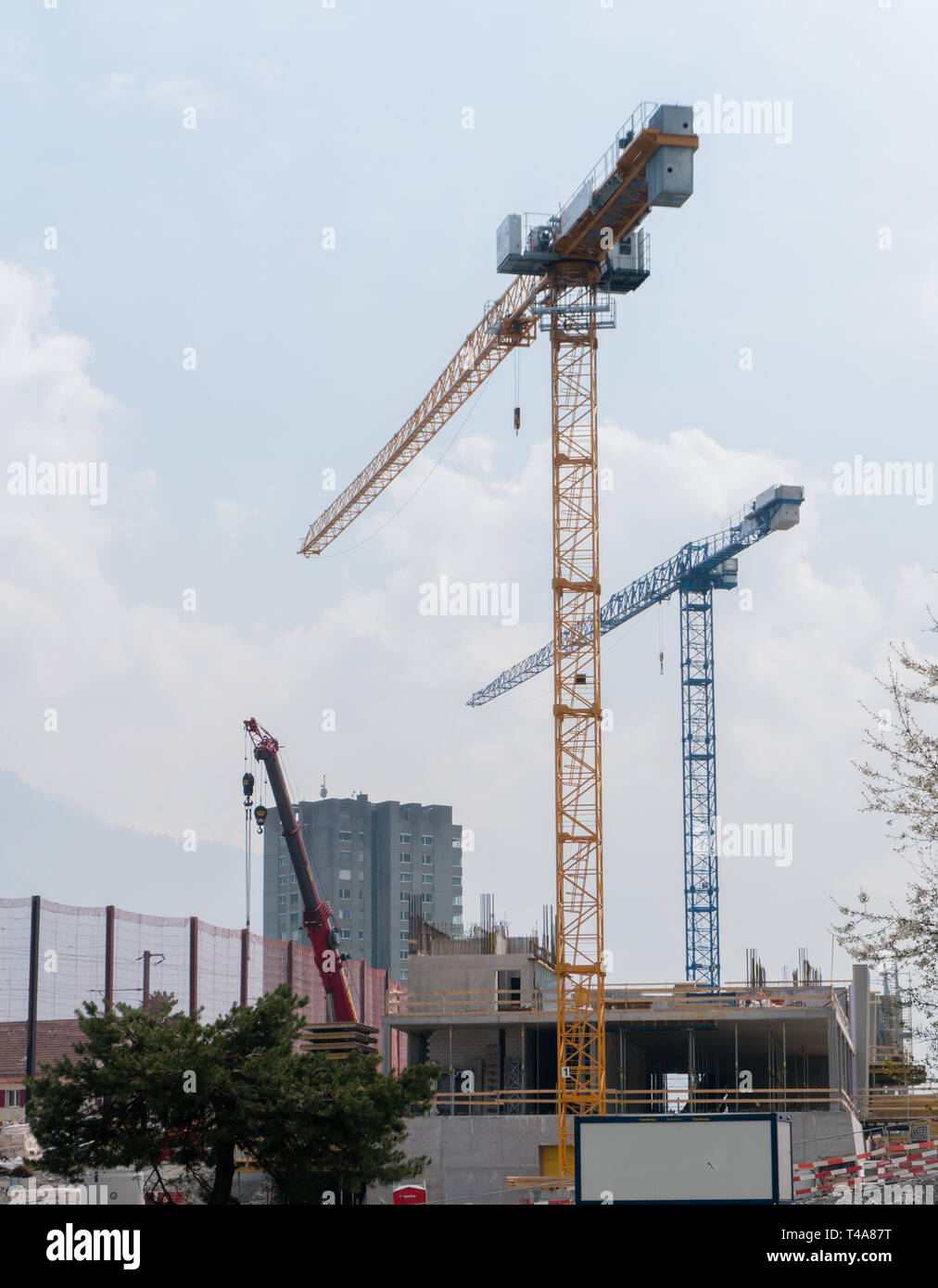 Landquart, GR / Switzerland - April 13, 2019: building site for new railroad bridge over the motorway in Landquart with large cranes behind Stock Photo