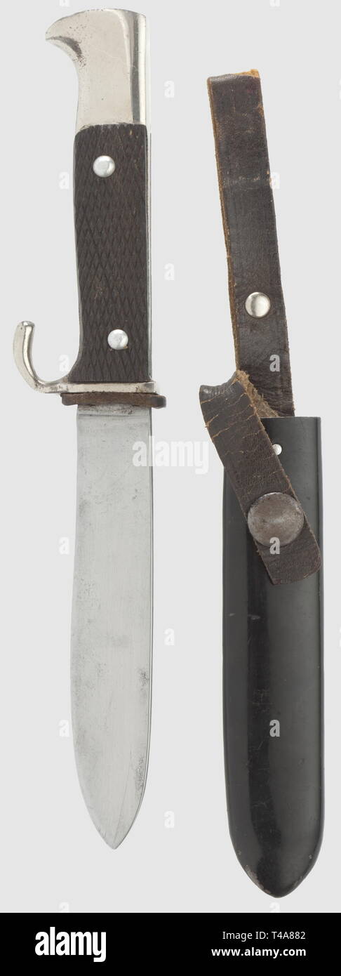 An early German Youth knife, Maker Anton Winger Jr, Solingen. The blade with etched maker's mark. Nickel-plated hilt with plastic grip plates. The quillon bent. Black lacquered iron scabbard with riveted brown leather hanger and safety strap with press button. Length 21 cm, historic, historical, 1930s, 1930s, 20th century, Hitler Youth, organisation, organization, organizations, organisations, youth organization, youth organizations, NS, National Socialism, Nazism, Third Reich, German Reich, knife, knives, thrusting, thrustings, weapon, arms, weapons, arms, object, objects,, Editorial-Use-Only Stock Photo