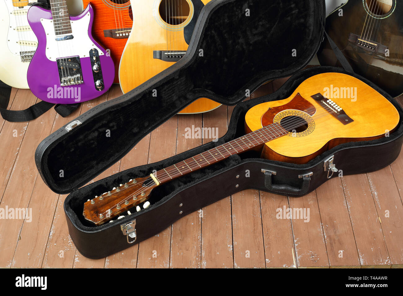 Musical instrument - Vintage twelve-string acoustic guitar hard case on a guitar and wooden background. Stock Photo