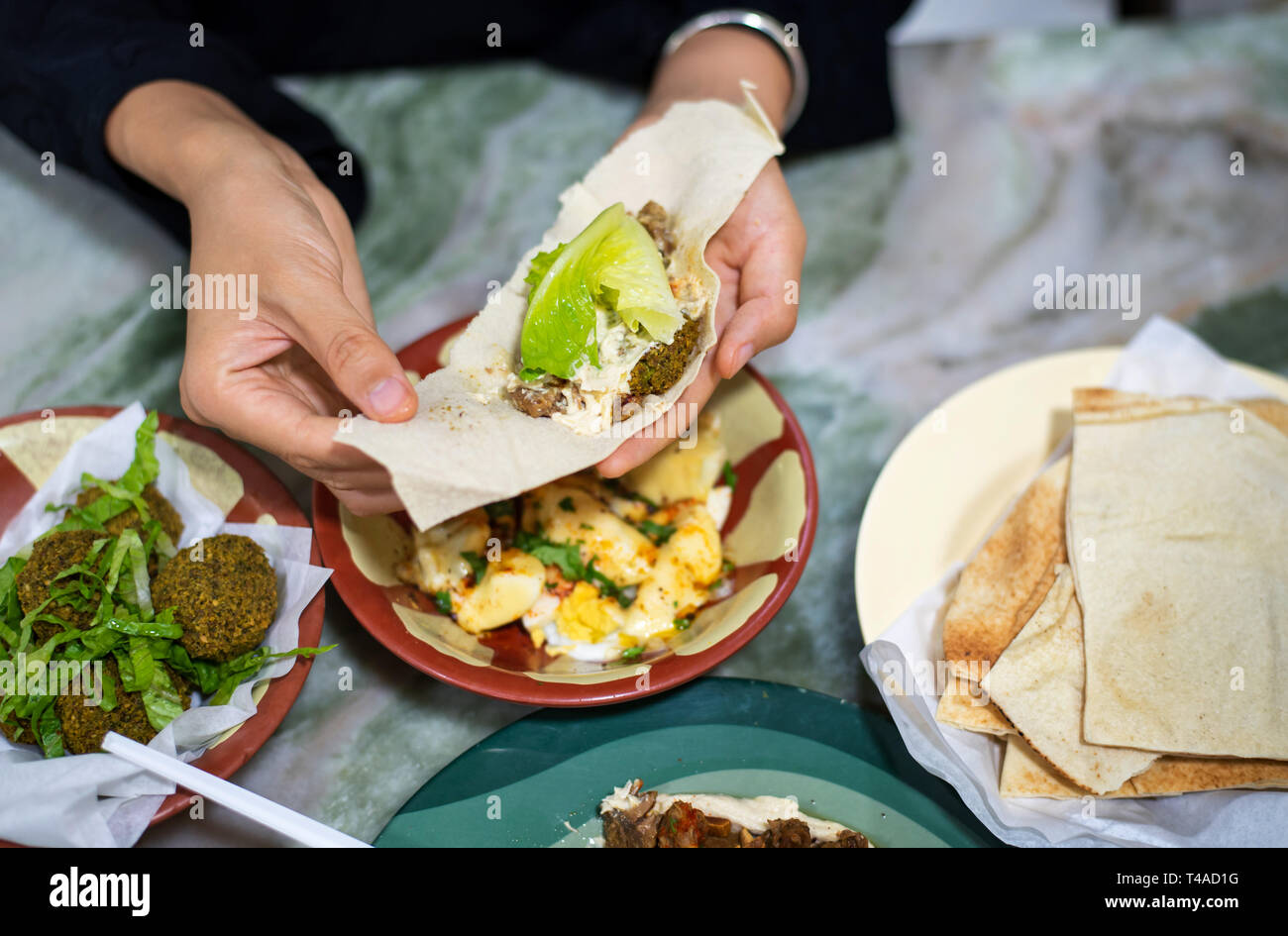 Woman having Arabic food in a restaurant close up Stock Photo