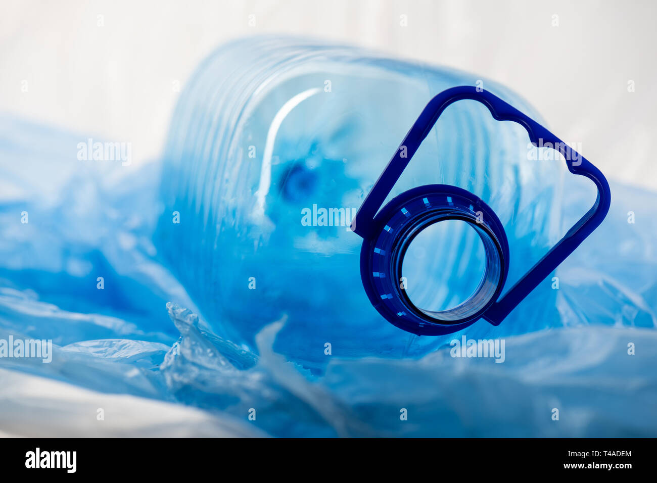 Big transparent opened water cane lying on thin plastic material Stock Photo