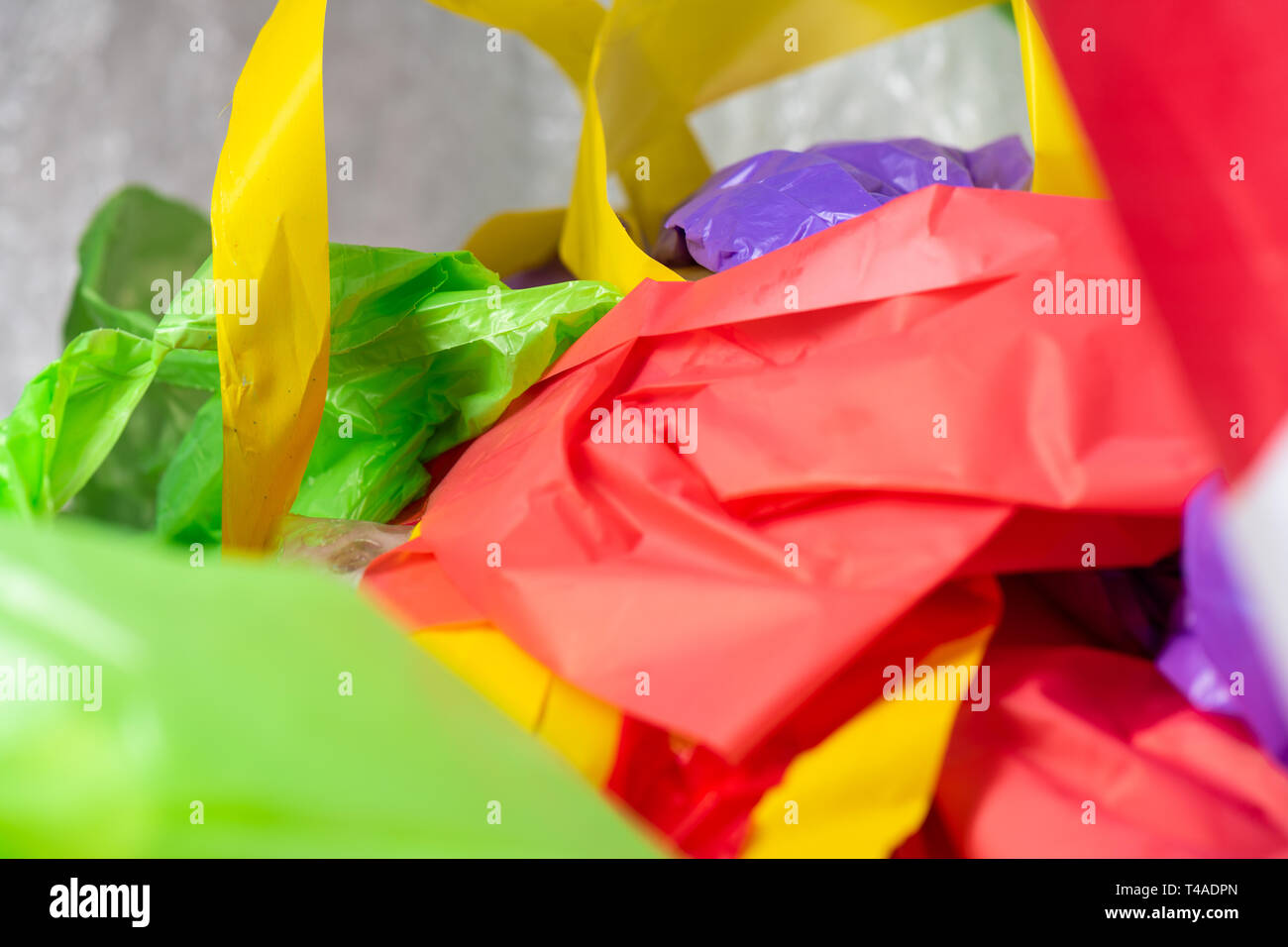 https://c8.alamy.com/comp/T4ADPN/bright-colorful-disposal-bags-and-materials-made-from-non-decomposable-plastic-T4ADPN.jpg