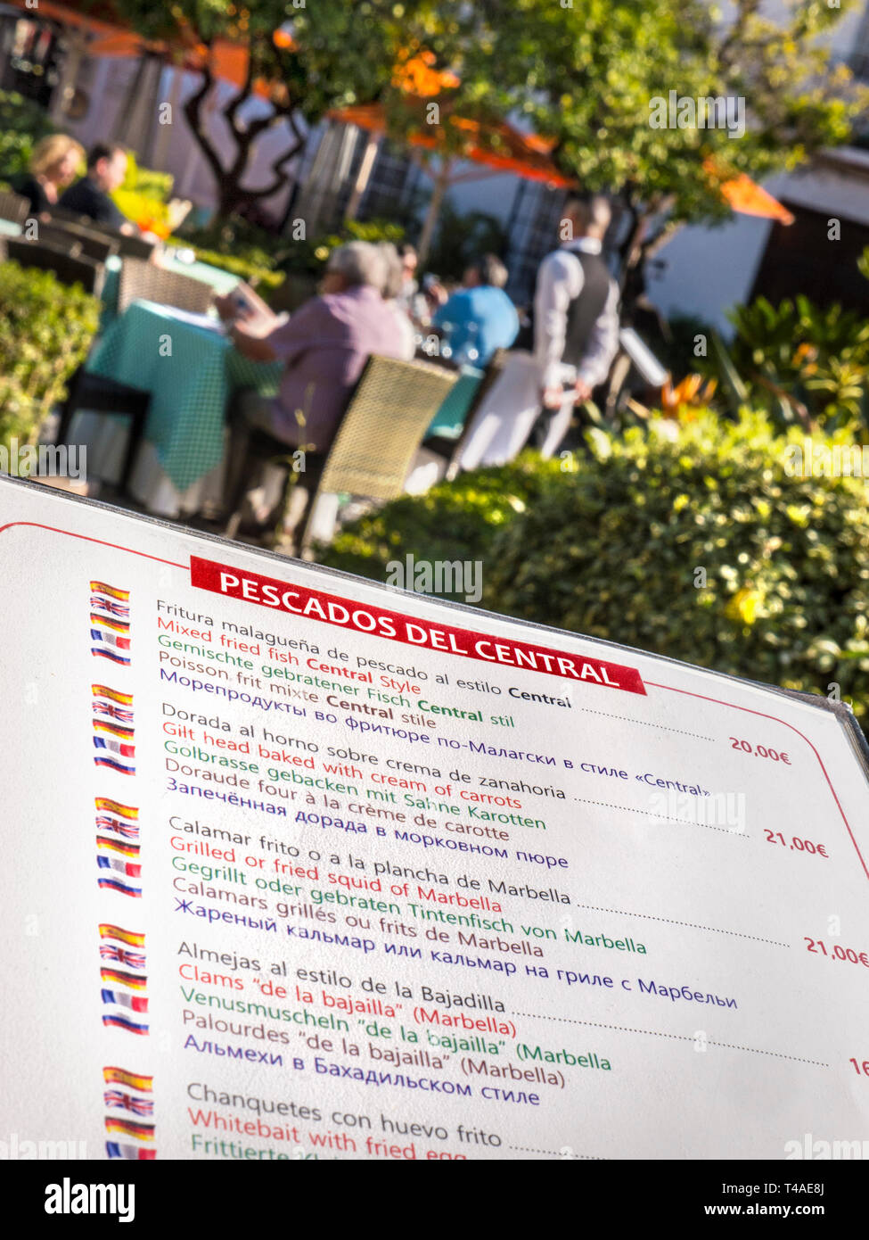 MENU ALFRESCO Spanish multilingual fish menu outdoor with waiter diners