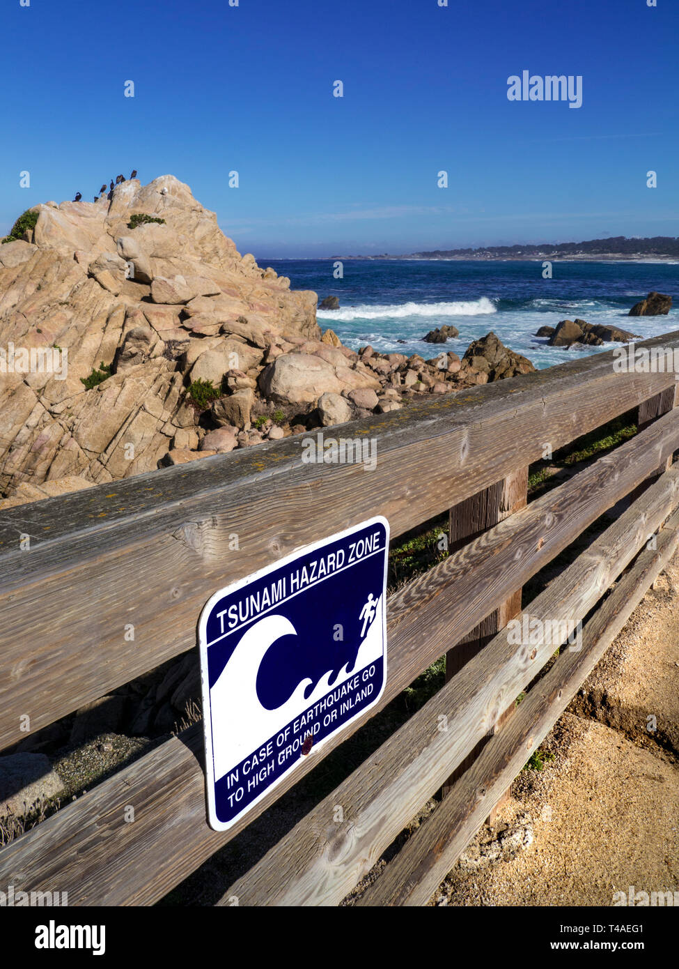 California Tsunami earthquake hazard zone sign on coastal 17 mile drive Pacific Grove Monterey California USA Stock Photo