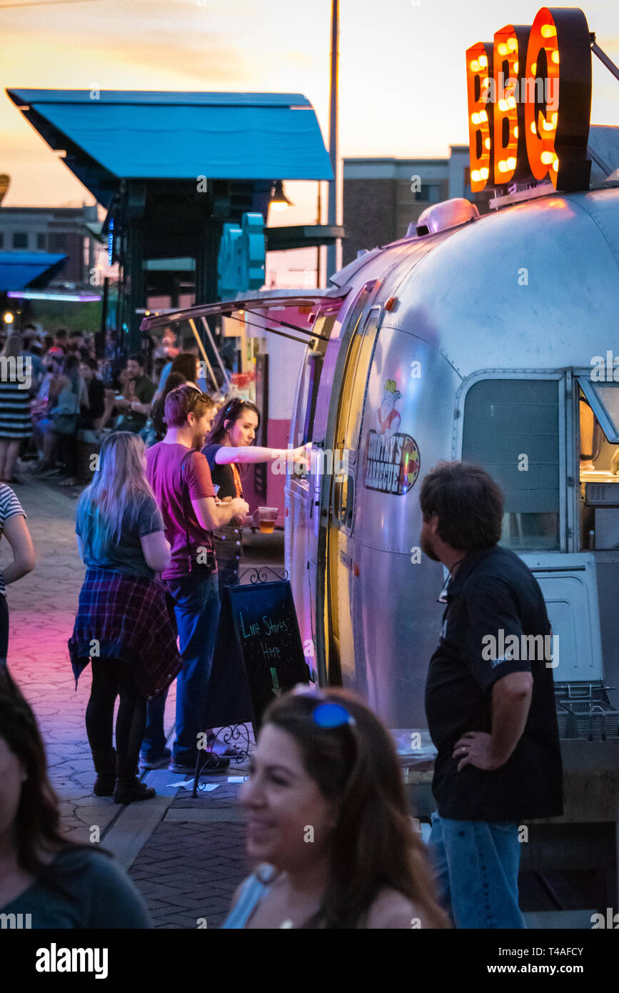 Creative South attendees ordering Southern cuisine from a BBQ food truck on the Pedestrian Bridge over the Chattahoochee River in Columbus, GA. Stock Photo