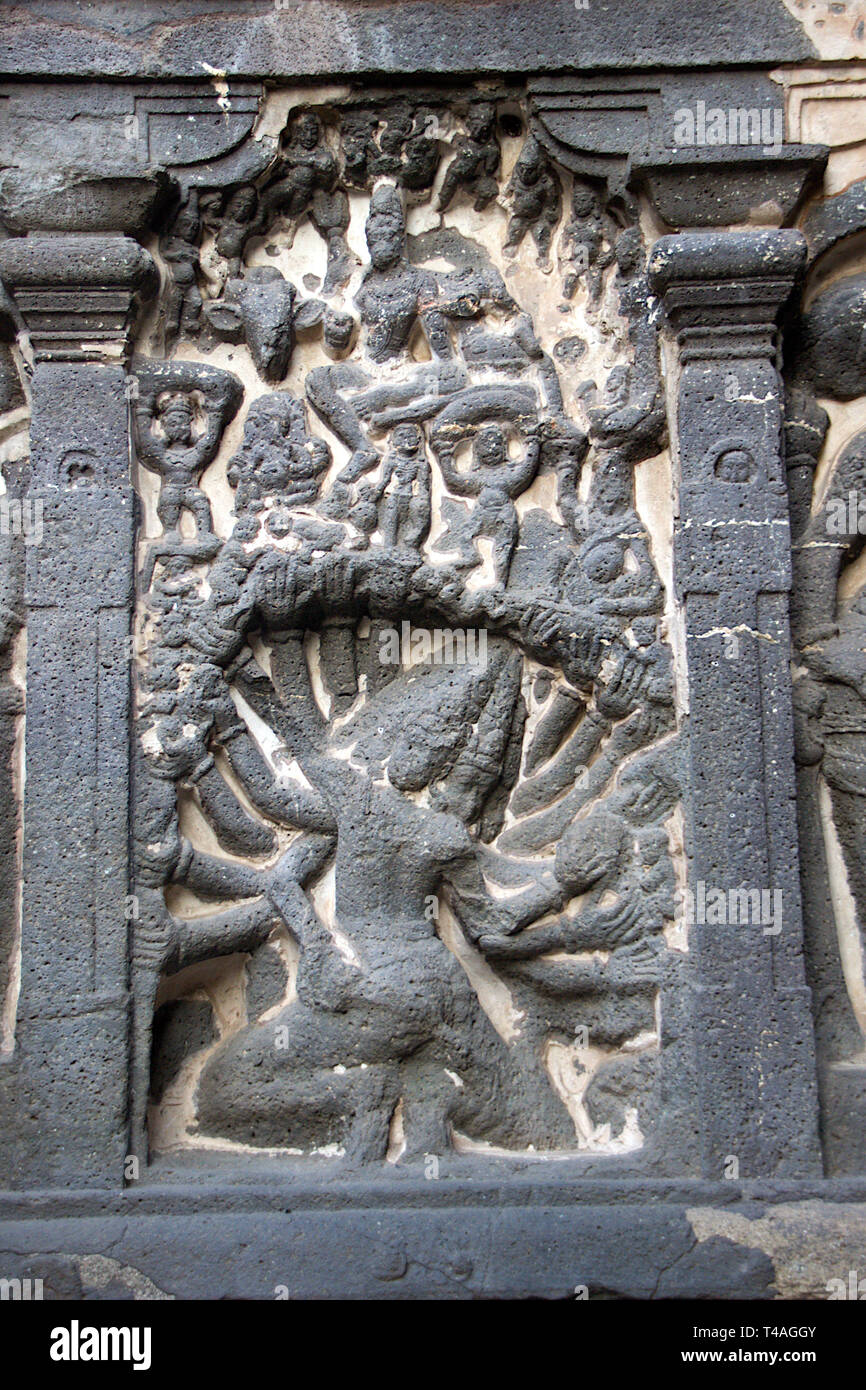 Bas relief carving of Ravana Lifting Mountain Kailash on wall of