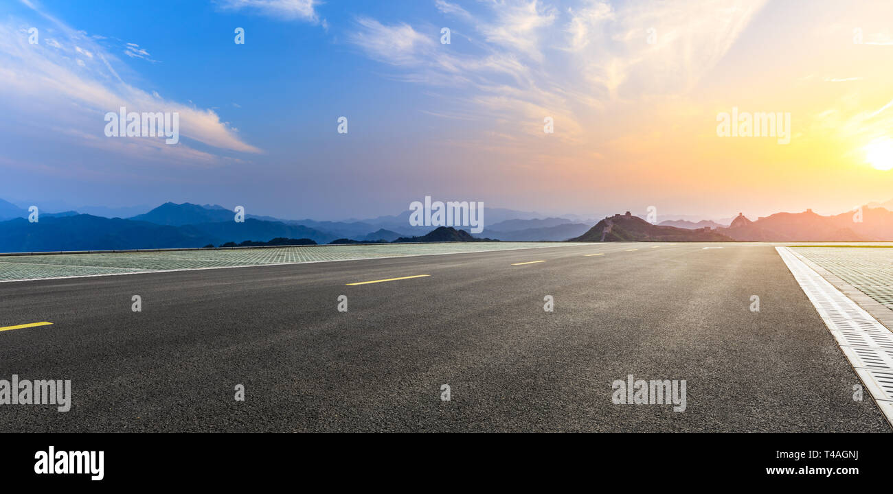 Asphalt road and beautiful mountain with great wall in China Stock Photo