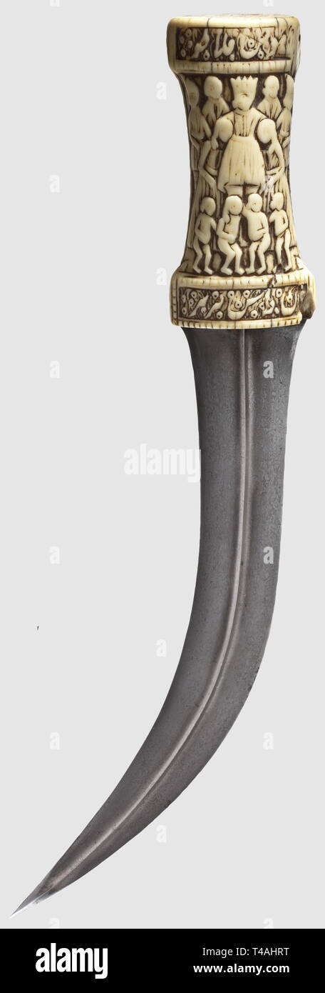 A Caucasian kinjal, circa 1900. A double-edged blade (somewhat stained)  with offset fullers on both sides and a ridged point. The silver grip  finely decorated on both sides with floral embossing and