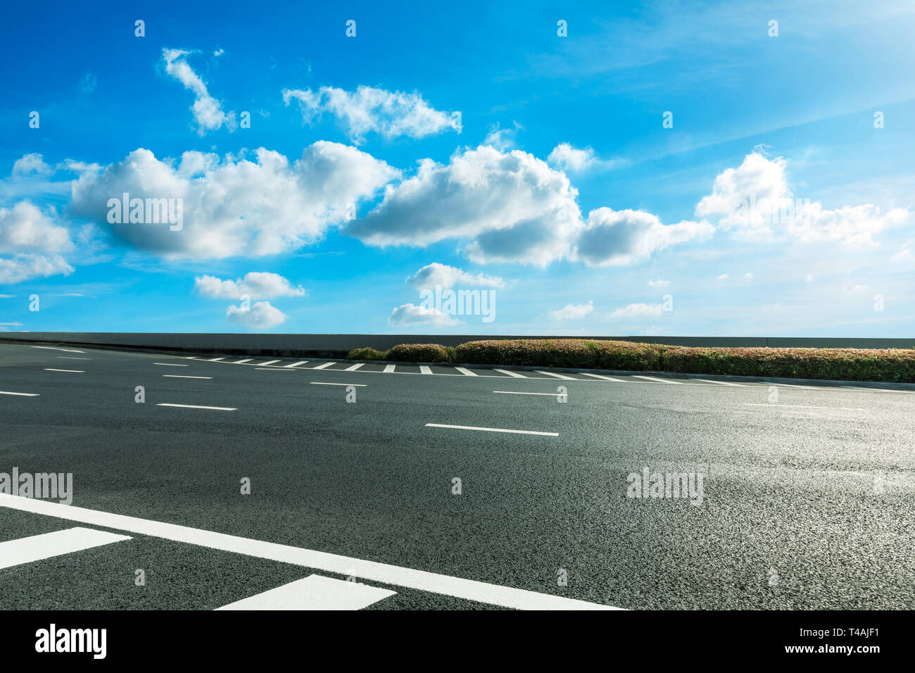 Empty asphalt road and blue sky with white clouds scene Stock Photo - Alamy