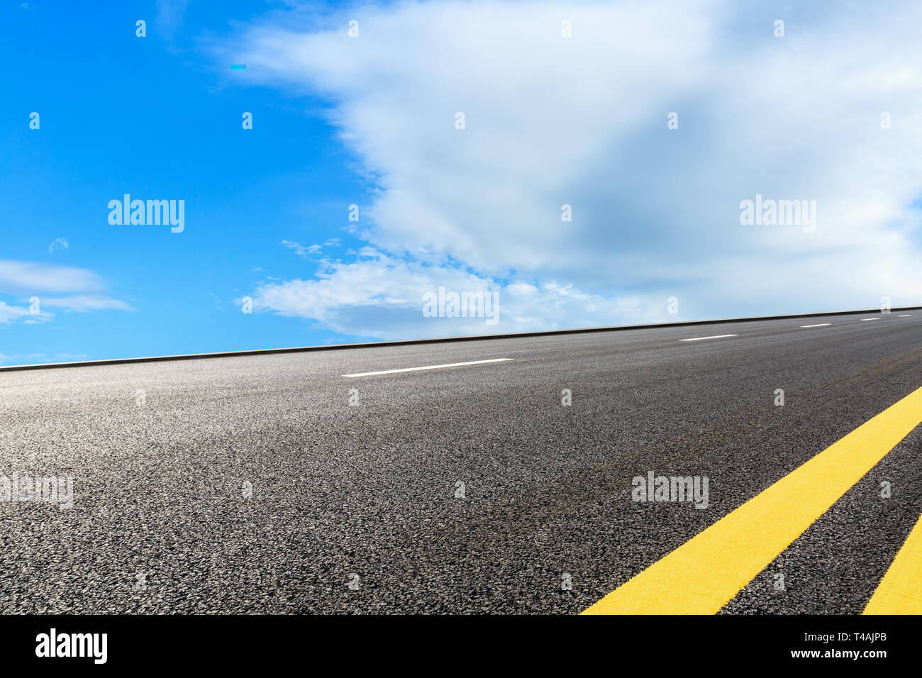 Empty asphalt road and blue sky with white clouds scene Stock Photo - Alamy